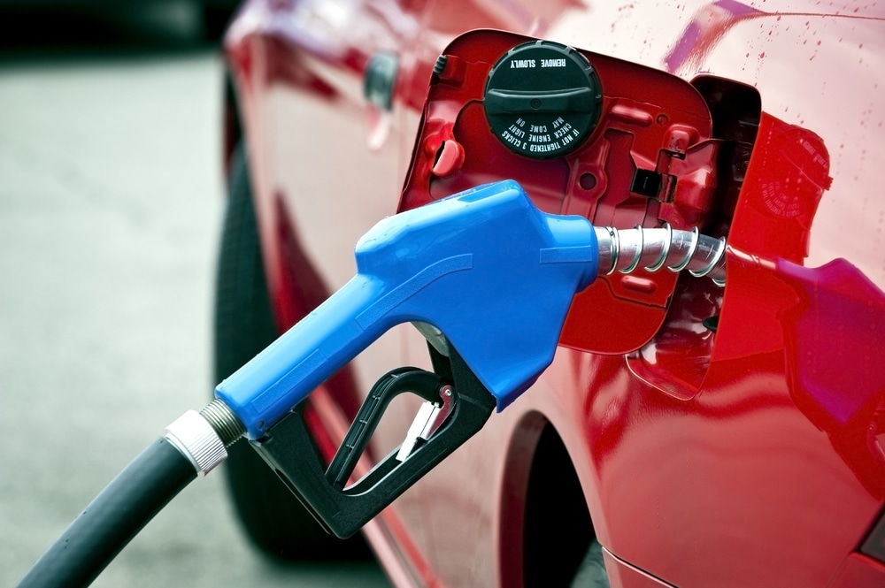 Blue Gasoline Nozzle Fueling Red Car